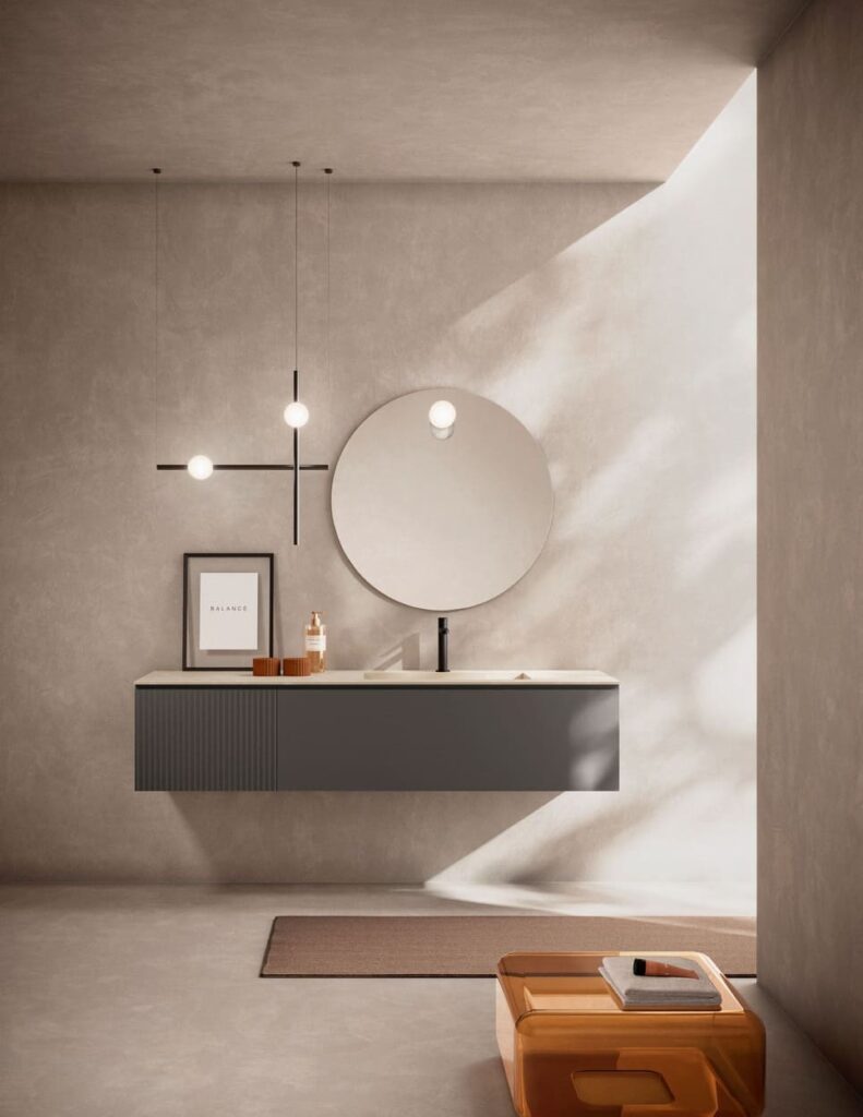 Mobile sospeso Artesi Petra grigio antracite con un modulo a superficie ondulata e un modulo liscio, specchio rotondo